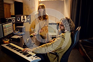 Male producer and female singer, recording studio