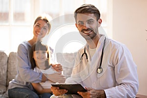 Male professional doctor pediatrician holding clipboard looking in camera