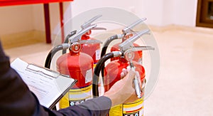 Male Professional inspection Fire extinguisher,safety concept