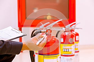 Male Professional inspection Fire extinguisher,safety concept