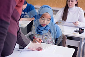 Male professor of architecture explain lesson to multiethnic students and interact with them in the modern classroom.Helping a