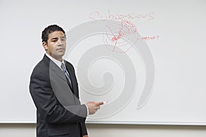 Male Professor Teaching On Whiteboard