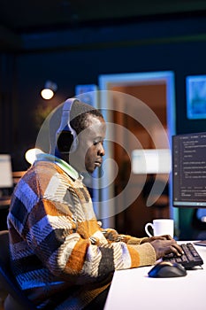 Male programmer working on developing new html script,