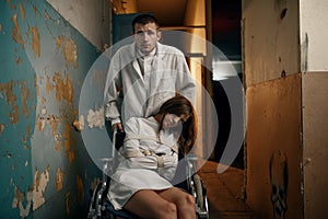 Male psychiatrist and female patient in wheelchair photo