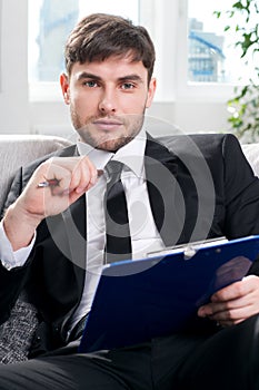 Male psychologist being ready to take notes