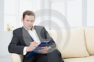 Male psychologist being ready to take notes photo