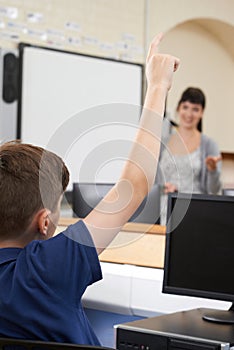 Male Pupil Answering Question In School Classroom