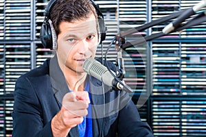 Male radio presenter in radio station on air