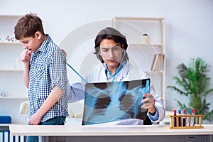 Male radiologist looking at boy`s images