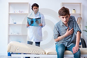 Male radiologist looking at boy`s images