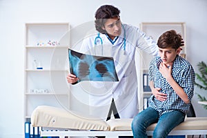 Male radiologist looking at boy`s images