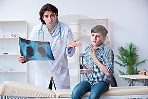 Male radiologist looking at boy`s images