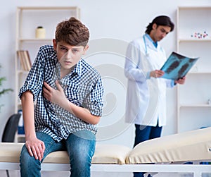 Male radiologist looking at boy's images