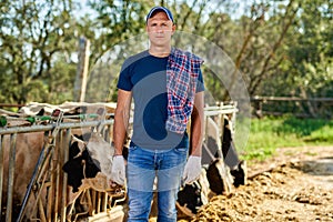 Male rancher in a farm cows.