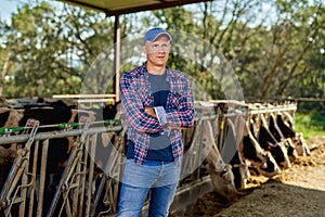 Male rancher in a farm cows