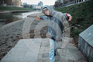 Male rapper posing on the street, urban dancing