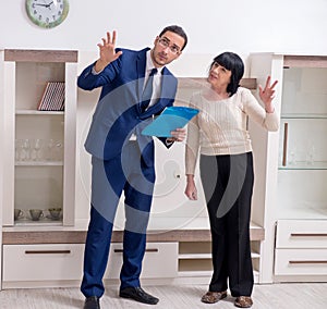 Male real estate agent and female client in the apartment