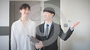 Male real estate agent with folder showing new house to client. Real estate mortgage and property investment concept