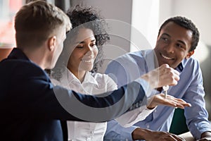 Male realtor give house keys to excited black couple