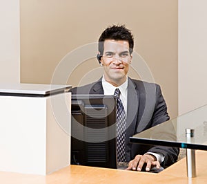 Male receptionist with telephone earpiece