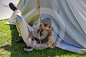 A Male Reenactor Relaxing at the Confederate Encampment