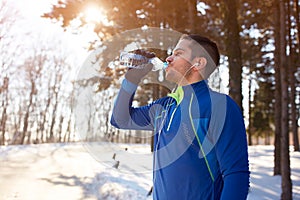 Male refreshes with water after running