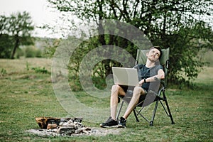 Male relaxing and work on vacation. Young man using online banking for sending money everywhere. Male traveler blogger work remote