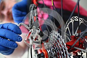 Male repair man bicycle service in blue protective