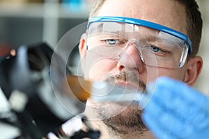 Male repairman looks at computer detail processor