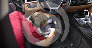 Male repairman vacuuming interior of car under seat 4k movie