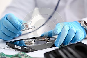 A male repairman wearing blue gloves