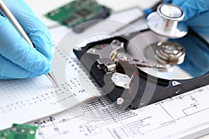 A male repairman wearing blue gloves