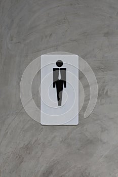 Male restroom sign on grey vintage cement wall background