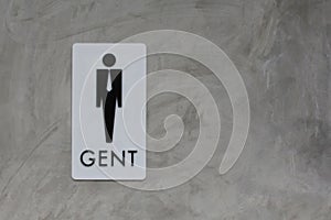 Male restroom sign on grey vintage cement wall background