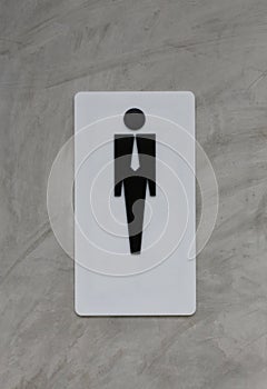 Male restroom sign on grey vintage cement wall background