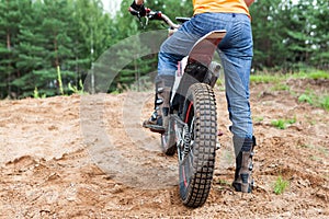 Male rider on motorcycle rides the sand. Extreme sports on motorcross motorcycles