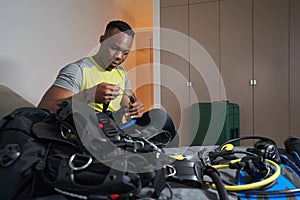 Male in room holding mask for scuba diving