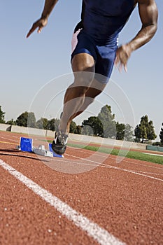 Male Runner Beginning Race From Starting Blocks