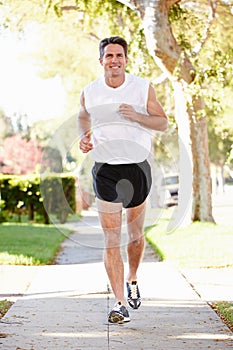 Male Runner Exercising On Suburban Street