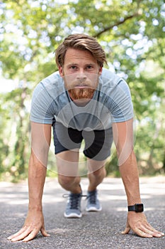 male runner poised to start photo