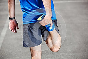 Male runner stretching