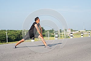 Male runners are stretching the leg muscles to prepare for a run