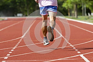 Male running at a track and field