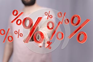 Male's hand touching floating 3D percentage signs
