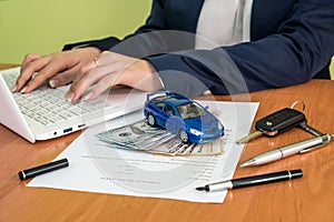 Male`s hands signing on car contract claim form and calculator, dollar