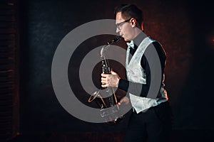 Male saxophonist playing classical jazz on sax