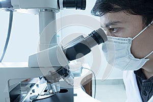 Male scientist doing microscope