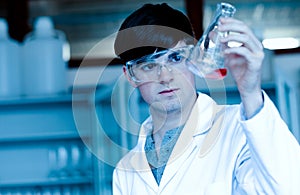 Male scientist looking at an Erlenmeyer flask