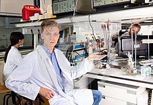 Male scientist sitting at biochemical lab