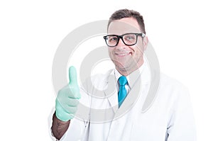 Male scientist smiling and showing thumb up gesture